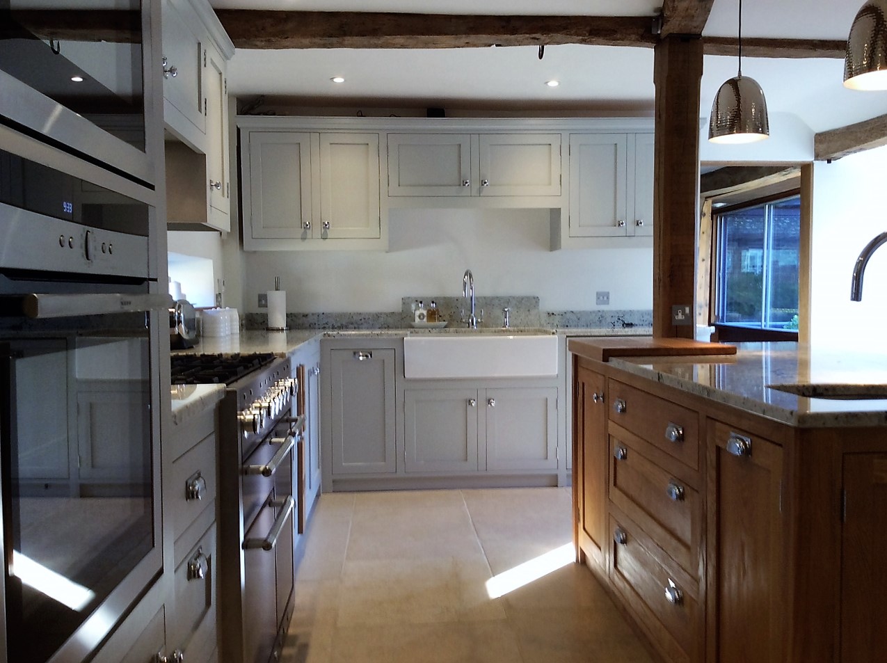 Tailor made  solid wood kitchen in the shaker style bespoke design for Barn in Oxfordshire.Feature solid oak island site ,belfast sink unit.