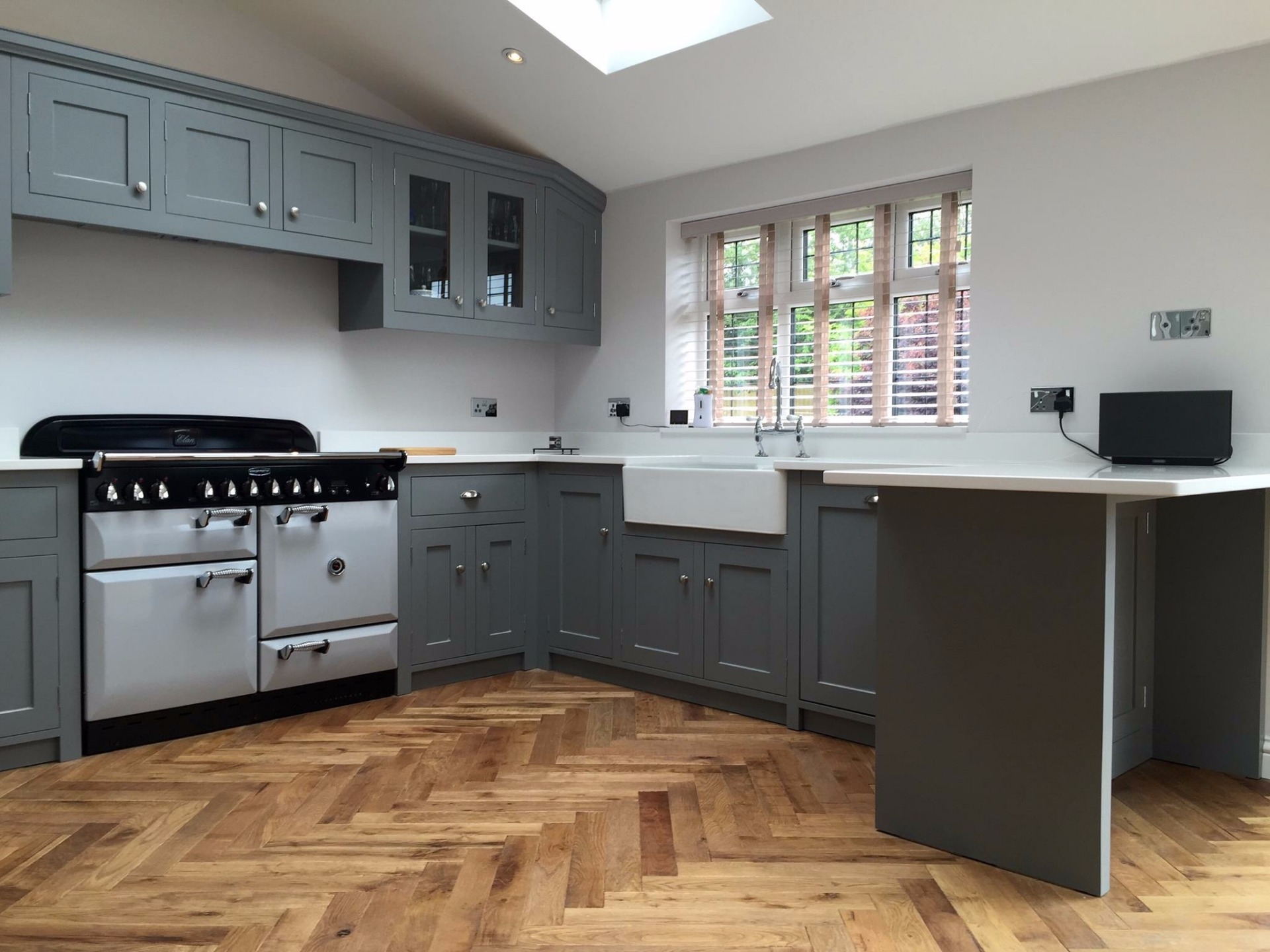 Fully bespoke shaker style fitted kitchen hand made from solid wood in shaker style with belfast sink painted in Farrow &Ball elephants breath.