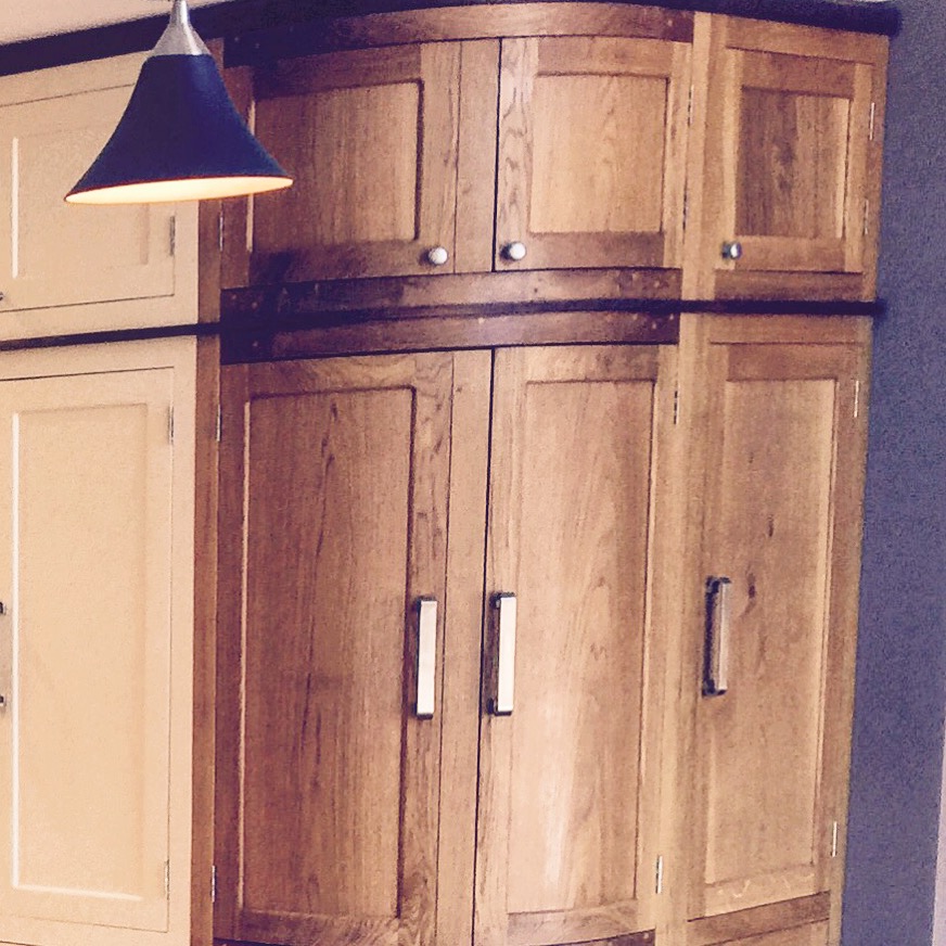 Fully bespoke shaker style fitted kitchen hand built from solid wood featuring curved cupboard. 