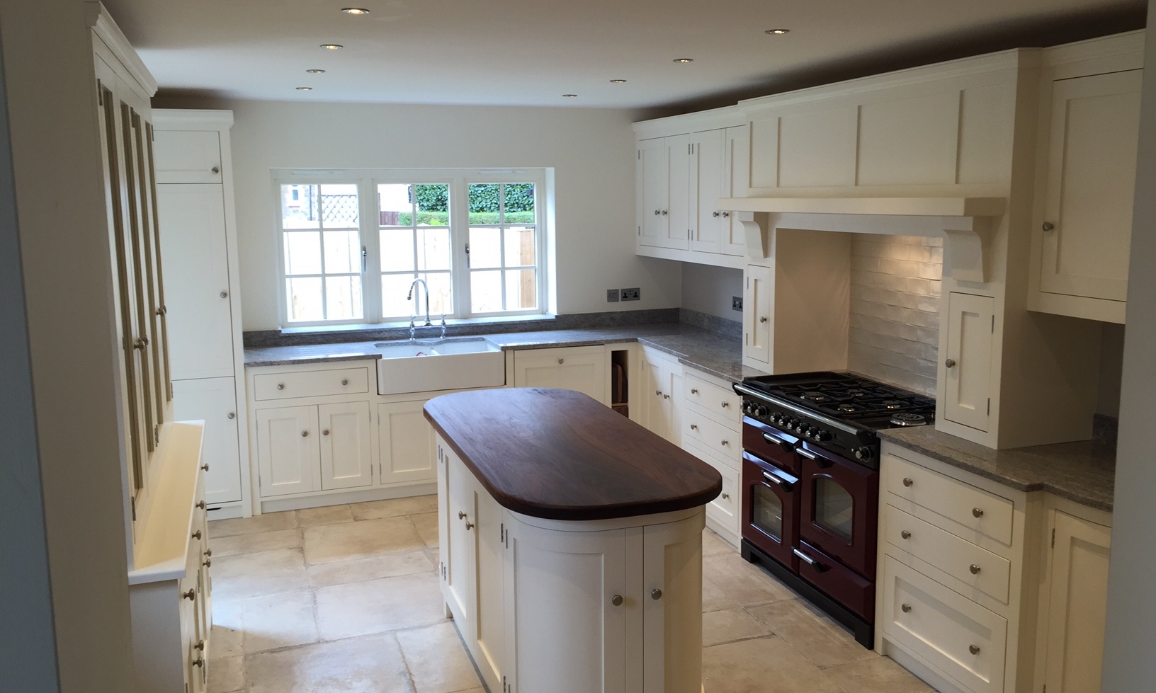Made to measure solid wood shaker style kitchen in solid wood hand built at our factory in Nottingham Painted in Farrow&Ball Pointing.Bespoke island site with solid wood black walnut top.